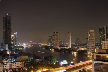 Fototapeta na wymiar bangkok night skyline with river and skyscrapers