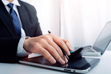 Businessman holding tablet and checking analyzing sales data growth graph chart and stock market on global networking. Business strategy, planning and digital marketing on blue background.