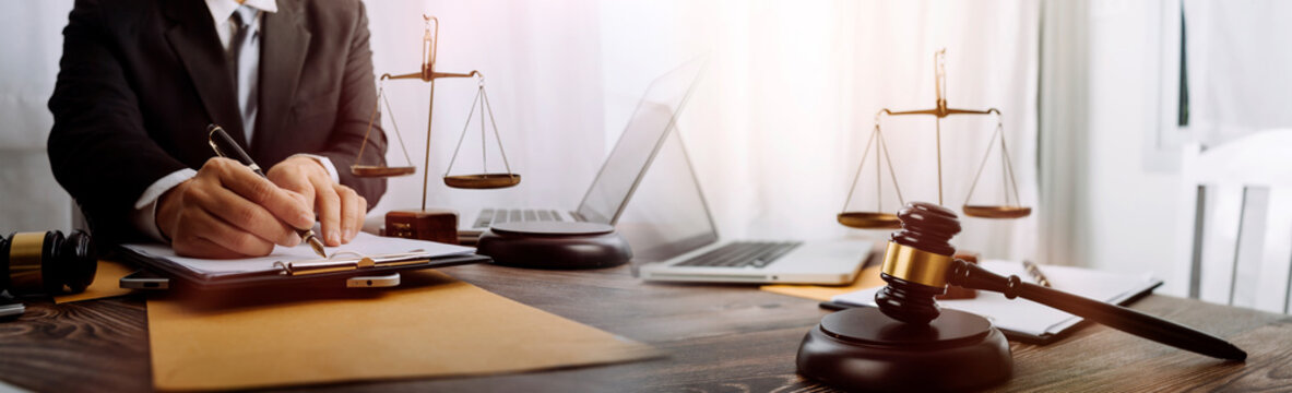 Business and lawyers discussing contract papers with brass scale on desk in office. Law, legal services, advice, justice and law concept picture with film grain effect