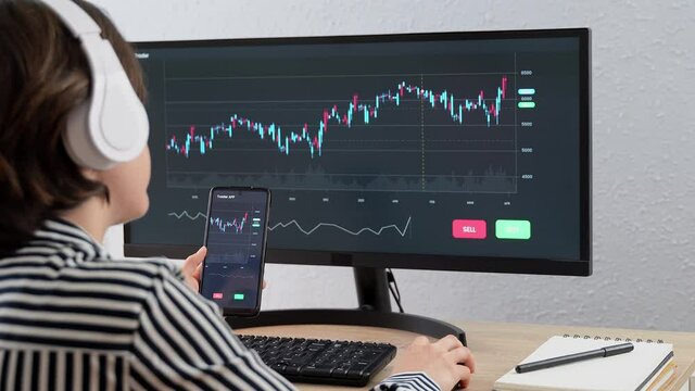 Trading business woman using stock market exchange app on computer and smartphone - Bitcoin, global economy concept