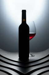 Bottle and glass of red wine.