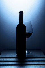 Bottle and glass of red wine.