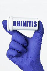 The doctor has a box of pills in his hands, the box says - RHINITIS