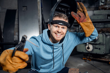 Portrait of young male student welder studying at industrial university or college