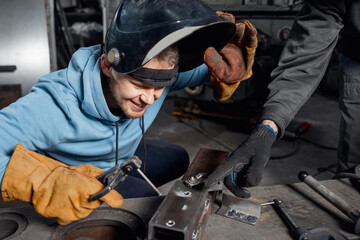 Training weld young male student welder studying at industrial university or college