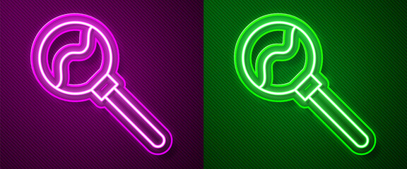 Glowing neon line Lollipop icon isolated on purple and green background. Food, delicious symbol. Happy Halloween party. Vector