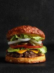 Juicy burger close-up on black background