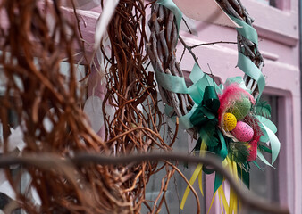 Easter composition of wreaths of branches and a nest with eggs.