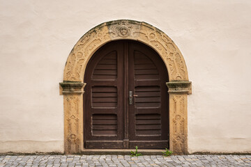 Fototapeta na wymiar An old arched double-leaf door.