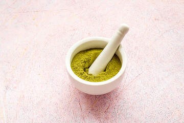 Henna powder in white mortar. Herbal natural hair dye
