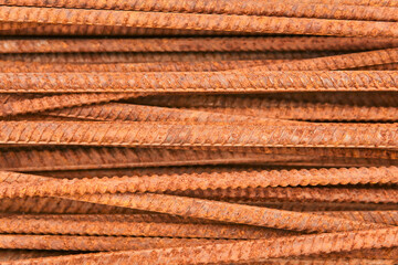 background - rusty reinforcing bars piled in a heap close-up