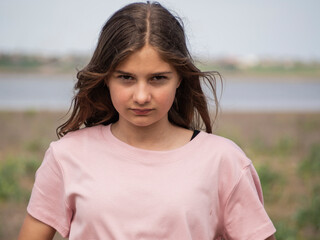 Cute angry girl, looks unkindly at the camera