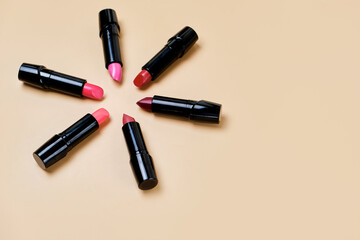 Obraz premium Flat lay composition with lipsticks and space for text on color background