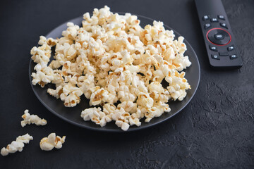 White salted popcorn for watching a movie on TV at home.