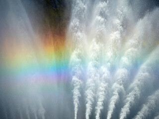 Bright rainbow in the streams of the fountain
