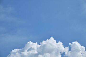 White clouds over blue sky horizontal with copyspace