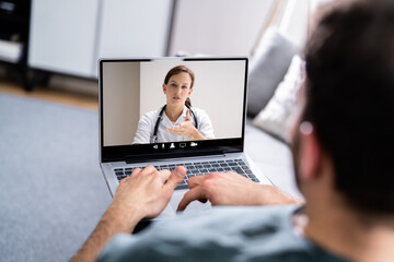 Man Having Video Chat With Doctor On Laptop