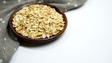 Oatmeal in a plate. Raw oatmeal, healthy food concept. Organic oatmeal, muesli.