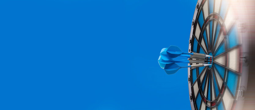 Target hit in the center by multiple arrows, multiple success concept, goals and targets banner