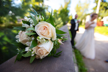 the bride and groom are holding a wedding bouquet. beautifully decorated flowers at the wedding ceremony. decoration of a family holiday