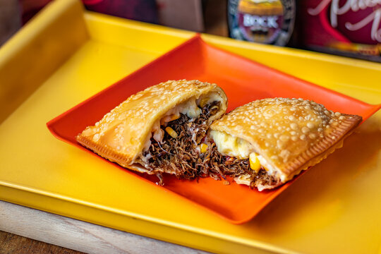 Brazilian typical pastry food stuffed with meat, cheese, barbecue salce, corn and eggs