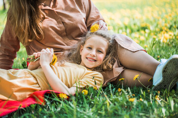 happy family on the bank near the river in summer in the park. Concept of family vacation in nature. mom and kids, mother's day