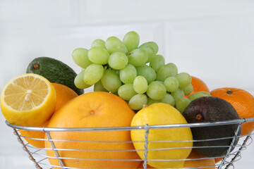 Fruits in a vase oranges grapefruits, tangerines, lemons, avocados, grapes