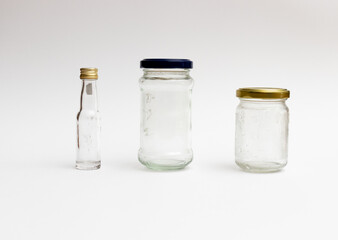 Empty glass containers on white background. Concept of reuse, zero waste and recycling