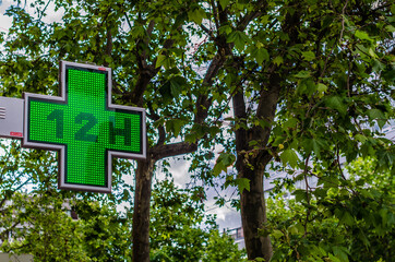 Green cross sign indicating pharmacy