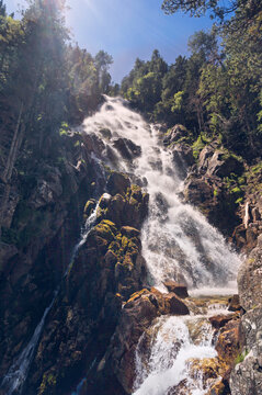 large waterfall with srong water goiign down faster, in Aran valley, Lerida, Spain.