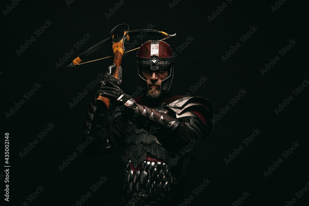 Wall mural Portrait of a medieval fighter holding a crossbow in his hands