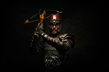 Portrait of a medieval fighter holding a crossbow in his hands