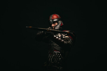 Portrait of a medieval fighter holding a crossbow in his hands