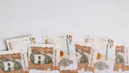 colombian money, five thousand pesos on white background