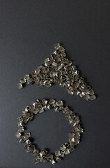old, worn, recycled square pyramidal metallic studs or spikes arranged in the shape of a circle and...