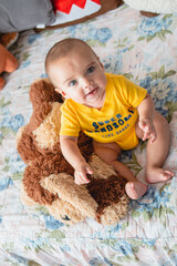 portrait of baby with stuffed animals in bed