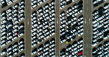 Aerial view of a large number of cars parked in angled parking spaces - aerial view  4K