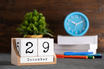 December 29th. December 29 wooden cube calendar with blur objects on background.
