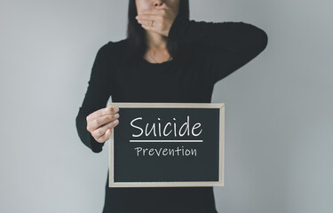 Woman hands holding banner with suicide prevention message,Mental health care concept