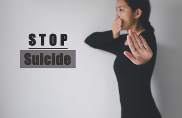 Against woman hands open with word stop suicide on white background,Suicide prevention concept