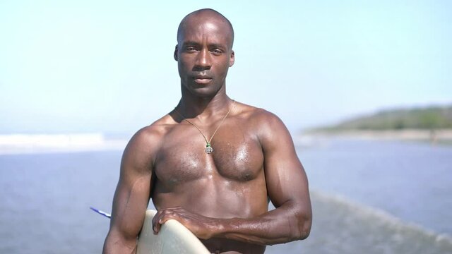 young fit african american black man on the beach to surf. Concept of strength, endurance, vitality,  motivation, health goals. Surfing. Summer Vacation.