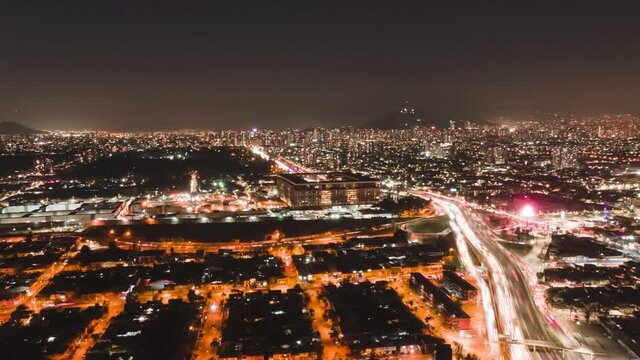Aerial hyperlapse at night in Santiago de Chile with cars in the route and city lights 