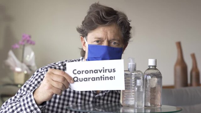 Quarantine, COVID-19, Man holding a paper, written, Coronavirus Quarantine. Focus on paper.