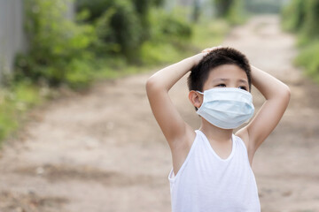 Portrait of little Asian boy wearing mask for protect pm2.5 pollution and coronavirus