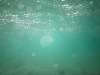 teal blue underwater blured swimming when waves rushing into