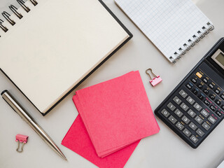 Blank notepad sheet and calendar for your congratulatory message. Closeup, top view. No people. Concept of preparation for a holiday. Congratulations for relatives, friends and colleagues