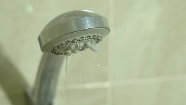 Leaking shower mixer. Water drops dripping from the bathroom faucet