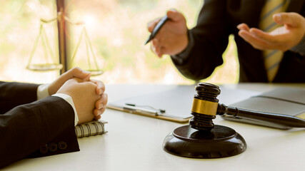 Lawyer Consulting Businessman in Office with Judge Hammer and Justice Scales with Laptop, Attorney Concept and Legal Consulting