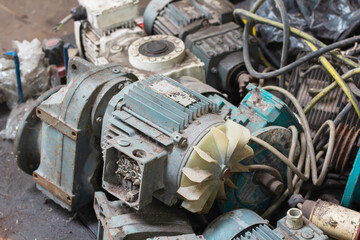 Old motor laid on the floor. The old motor is scrapped. Rusty old motor. Old motor waiting for...