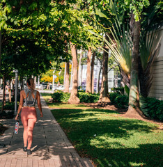Fototapeta na wymiar woman walking in the park beautiful green people sport summer Miami Florida 